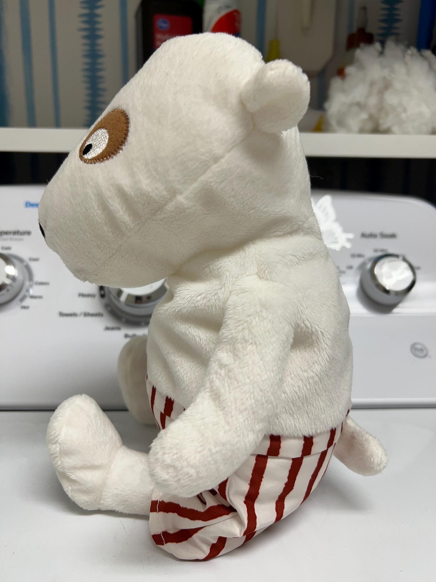 Ikea VANLIGHET White Dog Plush with red and white striped shorts.
